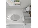 Bright bathroom featuring a pedestal sink, round mirror, toilet, and natural light from a window at 145 Gladstone Loop, Clayton, NC 27520