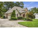 Beautiful home featuring brick and stone exterior and a spacious driveway at 1605 Hunting Ridge Rd, Raleigh, NC 27615