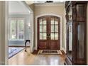 Grand foyer with hardwood floors, arched entryways, and a statement grandfather clock at 1605 Hunting Ridge Rd, Raleigh, NC 27615
