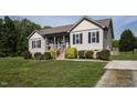 Charming home with well-manicured lawn, flower boxes, and a welcoming front porch at 164 Tillburg Ln, Hurdle Mills, NC 27541