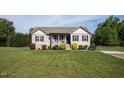 Charming single-story home with well-maintained lawn, black shutters, and a concrete driveway at 164 Tillburg Ln, Hurdle Mills, NC 27541