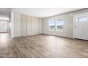 Inviting living room with wood-look floors, large windows, and elegant paneling at 17 Star Dust Ln, Selma, NC 27576