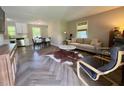 Open-concept living space boasts stylish herringbone floors and abundant natural light at 1708 Sundial Pl, Raleigh, NC 27610