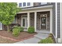 A front porch with brick columns and a well manicured lawn at 1844 Austin Ridge Pkwy, Wake Forest, NC 27587