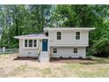Charming two-story home with a freshly painted brick facade, bright blue door, and landscaped front yard at 1903 Meadowbrook St, Sanford, NC 27330