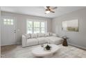 Cozy living room featuring a large window, plush seating, and stylish decor at 1903 Meadowbrook St, Sanford, NC 27330