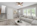 Bright living room with hardwood floors, ceiling fan, and a comfortable couch at 1903 Meadowbrook St, Sanford, NC 27330