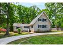 Attractive home featuring blue shutters, manicured lawn, and a welcoming entrance, all in a tranquil setting at 1915 Redding Ln, Durham, NC 27712