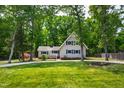 Charming two-story home with blue shutters, a well-manicured lawn, and mature trees at 1915 Redding Ln, Durham, NC 27712