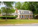 Charming brick home featuring a well-maintained lawn and mature trees in a picturesque setting at 2021 Sunnybrook Dr, Burlington, NC 27215