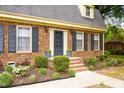 Inviting front entrance with brick steps, elegant shutters, and a well-maintained garden at 2021 Sunnybrook Dr, Burlington, NC 27215
