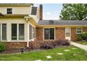 Back of house with sliding glass doors and landscaped yard at 2021 Sunnybrook Dr, Burlington, NC 27215