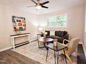 Inviting living room with a ceiling fan, ample natural light, and modern decor at 2222 Oak Ridge Blvd, Durham, NC 27707