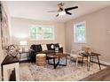 Bright living room with neutral walls, plush rug, contemporary furniture and ceiling fan at 2222 Oak Ridge Blvd, Durham, NC 27707
