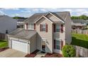 Well-maintained two-story home with attached two-car garage and manicured front yard at 2503 Macdougall Dr, Burlington, NC 27217