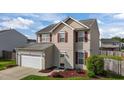 Inviting two-story home with red shutters, attached garage, and professionally landscaped front yard at 2503 Macdougall Dr, Burlington, NC 27217