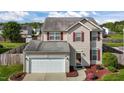 Attractive two-story home with red shutters, attached two-car garage, and a tree-lined backdrop at 2503 Macdougall Dr, Burlington, NC 27217