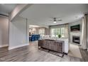 Open concept living room featuring wood floors, a fireplace, and seamless flow to dining area at 3004 Dog Rose Dr # 309, Durham, NC 27703