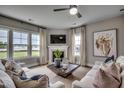 Cozy living room with a fireplace, plush sofas, and abundant natural light from large windows at 3004 Dog Rose Dr # 309, Durham, NC 27703
