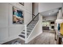 View of the staircase with decorative iron railing and a view to the living room at 3004 Dog Rose Dr # 309, Durham, NC 27703