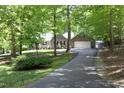Lovely home with an attached garage nestled amidst towering trees accessible by a long paved drive at 320 Delvin Lane Ln, Hillsborough, NC 27278