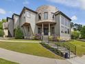 Attractive home showcasing a stone turret, multiple windows, and landscaped front yard at 3315 Denada Path, Durham, NC 27707