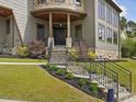 Charming front entrance with stone steps, wrought iron railings, and manicured landscaping at 3315 Denada Path, Durham, NC 27707