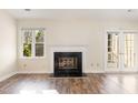 Living room area with fireplace, natural light and door that lead to deck at 3325 Tarleton E, Durham, NC 27713