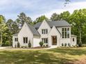 Elegant white brick home with a manicured lawn and mature trees at 40 Ridgeline Ct # 10, Pittsboro, NC 27312