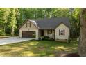 Charming single Gathering home showcasing a manicured lawn, rocking chairs, and attached garage at 4005 Colleen Way, Kittrell, NC 27544