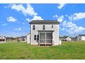 Spacious backyard featuring a well-maintained lawn and a cozy screened-in porch at 47 Peduncle St, Selma, NC 27576