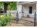 Cozy front porch with lattice and wrought iron fencing, surrounded by lush greenery at 511 E Maynard Ave, Durham, NC 27704