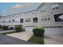 Inviting townhome featuring neutral siding, multi-car garage and well maintained landscaping at 5927 Hourglass Ct, Raleigh, NC 27612