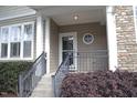 Inviting front porch with stone accents, manicured shrubs, and a stylish entrance at 5927 Hourglass Ct, Raleigh, NC 27612