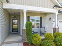 Welcoming front porch with seating, manicured shrubs, and an inviting entrance at 60 Heart Pine Dr, Wendell, NC 27591