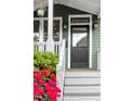 Inviting front entrance with a stylish black door and well-manicured landscaping at 616 Dorothea Dr, Raleigh, NC 27603