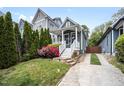Charming home featuring a welcoming front porch and beautifully landscaped yard with colorful flowers at 616 Dorothea Dr, Raleigh, NC 27603