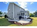 Spacious backyard with a stone patio and screened-in porch at 638 Boulder Point Dr, Chapel Hill, NC 27516