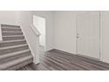 Inviting entryway featuring hardwood flooring, a staircase and natural light from the door at 704 Shepard Rock Dr, Zebulon, NC 27597