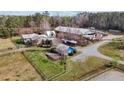 Exterior view of the home with a large barn and outbuildings on a sprawling property with a fenced pasture at 754 Epps Clark Rd, Siler City, NC 27344