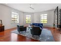 Bright living room featuring hardwood floors, large windows, and stylish furniture at 101 Morris St # D, Durham, NC 27701