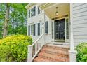 Inviting front entrance with brick steps and black front door with decorative accents at 105 Parkmount Cir, Cary, NC 27519