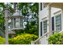 Close up view of a vintage lamp post in the front yard with house number in background at 105 Parkmount Cir, Cary, NC 27519