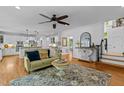 Spacious living room with hardwood floors, a decorative rug, and a view into the kitchen at 106 Birkhaven Dr, Cary, NC 27518