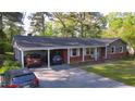 Well-maintained brick home featuring a convenient carport and a classic design at 109 Edgewood Dr, Louisburg, NC 27549