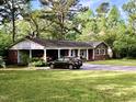 Inviting brick home with a convenient carport, surrounded by a well-manicured lawn at 109 Edgewood Dr, Louisburg, NC 27549