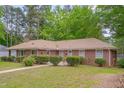 Brick home featuring mature landscaping and a well-manicured lawn at 1105 Hargrove St, Henderson, NC 27536