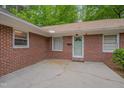 Exterior shot showcasing the brick facade and concrete walkway at 1105 Hargrove St, Henderson, NC 27536