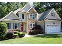 Charming two-story home featuring stone accents, gray siding, a well-manicured lawn and a two car garage at 1108 Kalworth Rd, Wake Forest, NC 27587