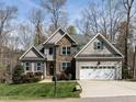 Beautiful two-story home featuring stone accents, a two-car garage, and a well-manicured lawn at 1108 Kalworth Rd, Wake Forest, NC 27587
